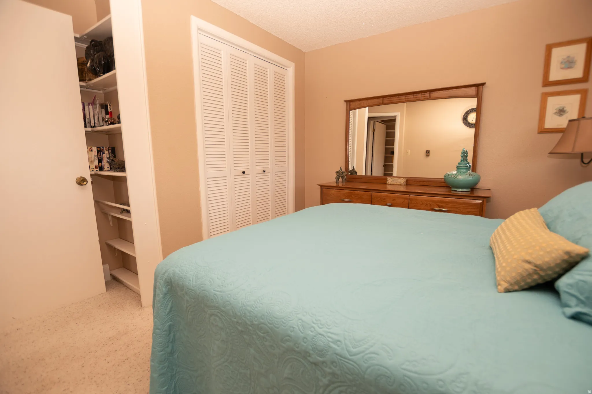 Bedroom featuring a textured ceiling and a closet