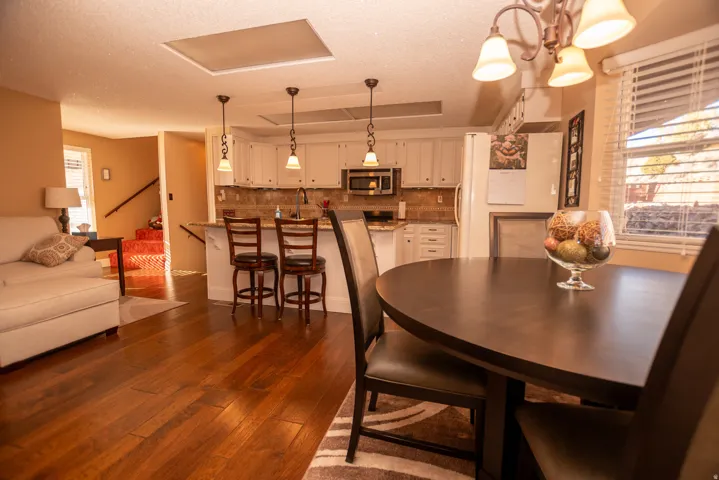 Dining space with dark wood finished floors and a textured ceiling