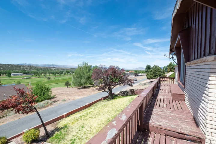 Elevated outdoor deck with wooden railing and built-in bench seating