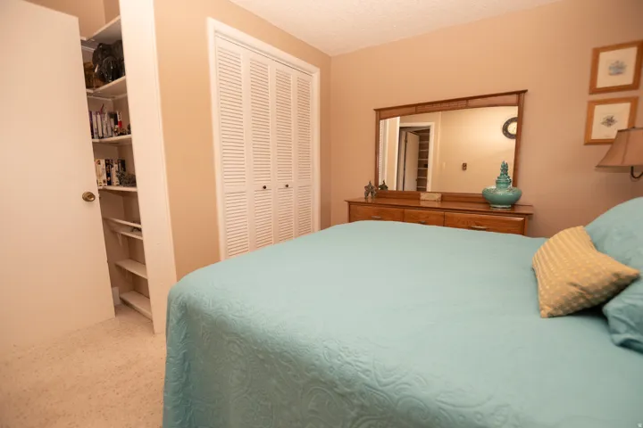 Bedroom featuring a textured ceiling and a closet
