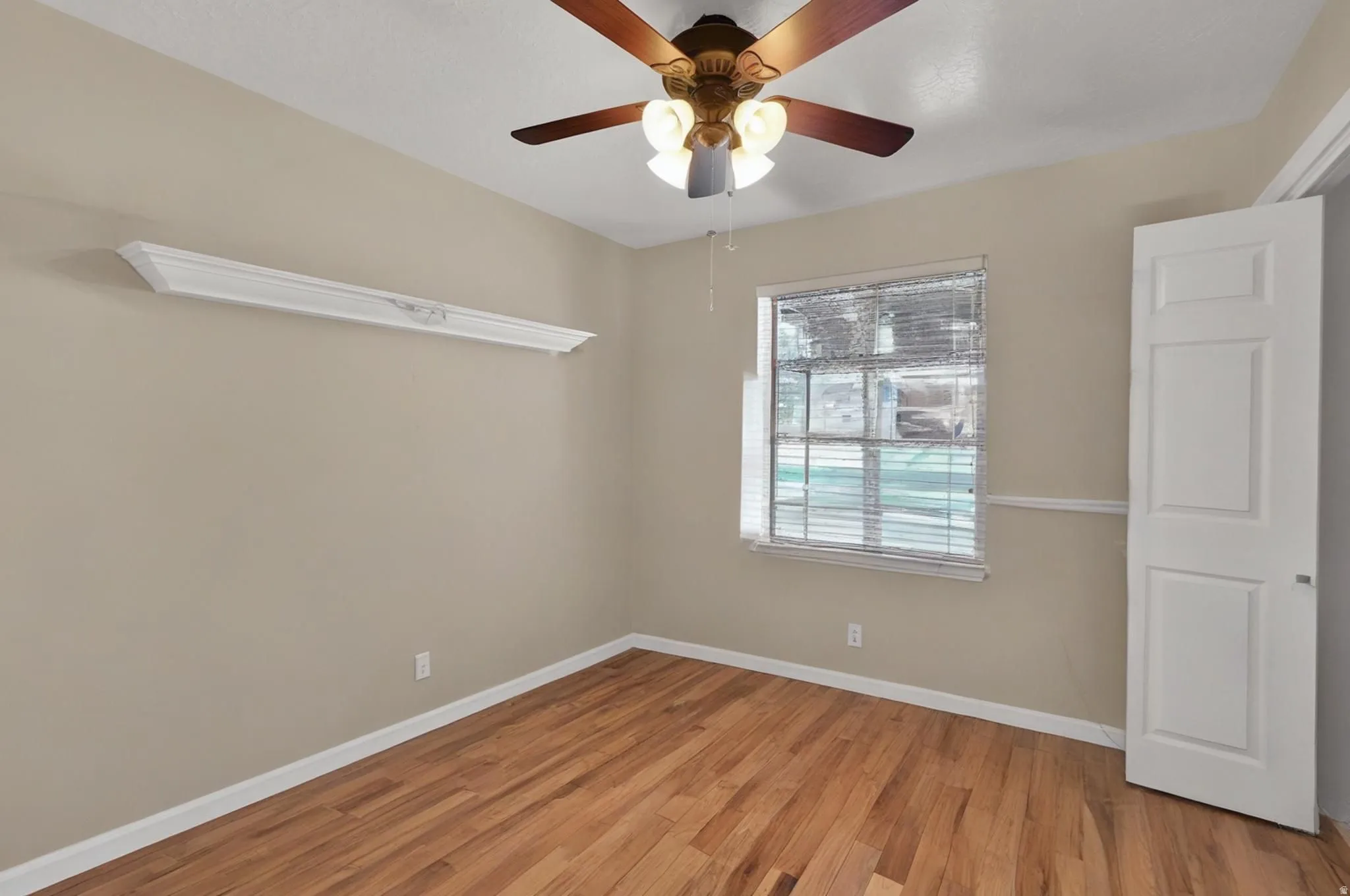 Bedroom featuring light wood-style flooring and a ceiling fan