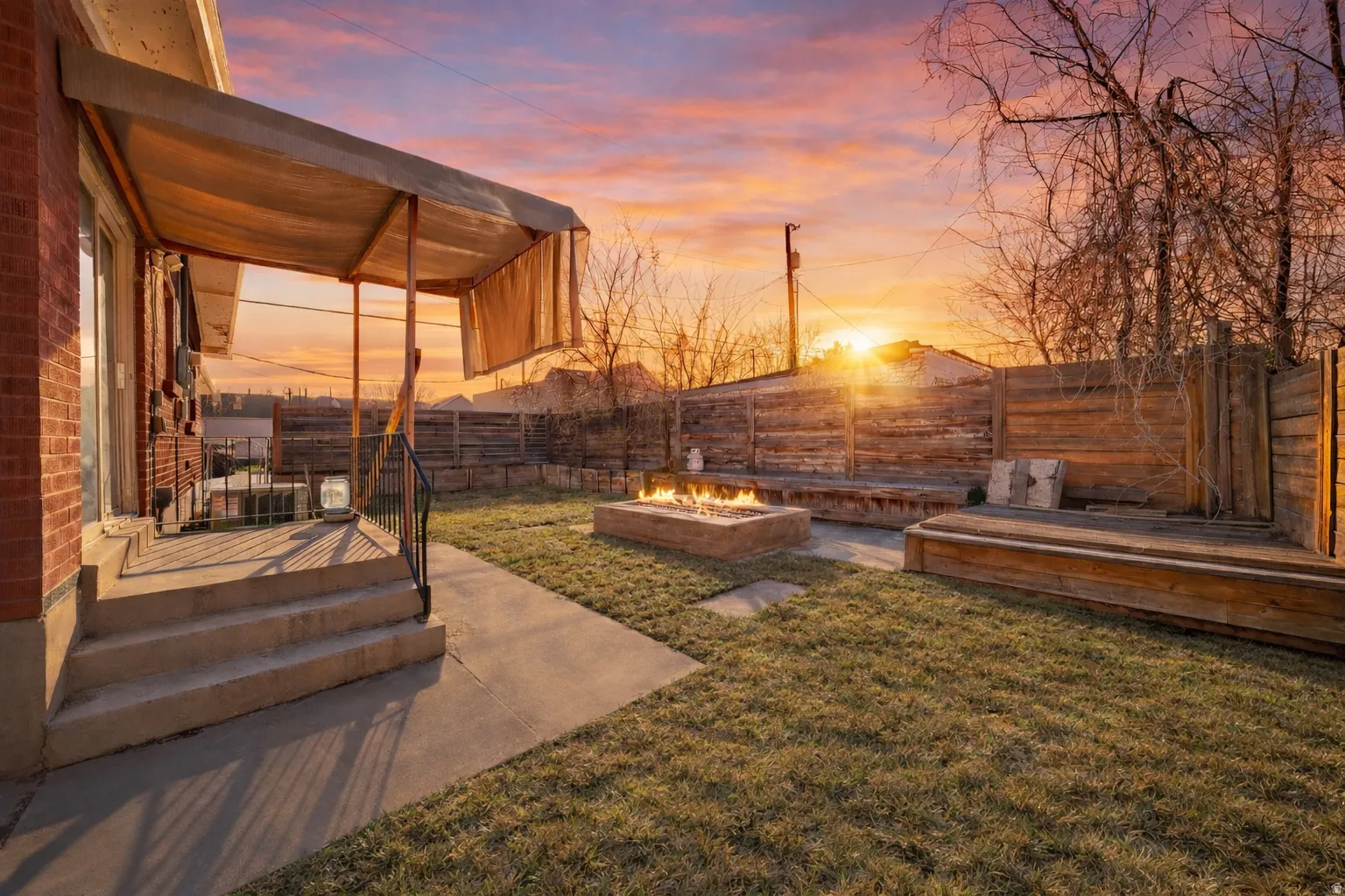 Fenced backyard featuring a patio area and an outdoor fire pit