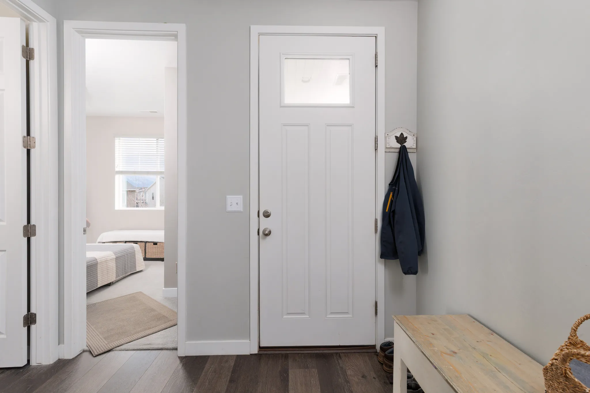 Entrance foyer featuring dark wood-style flooring and baseboards
