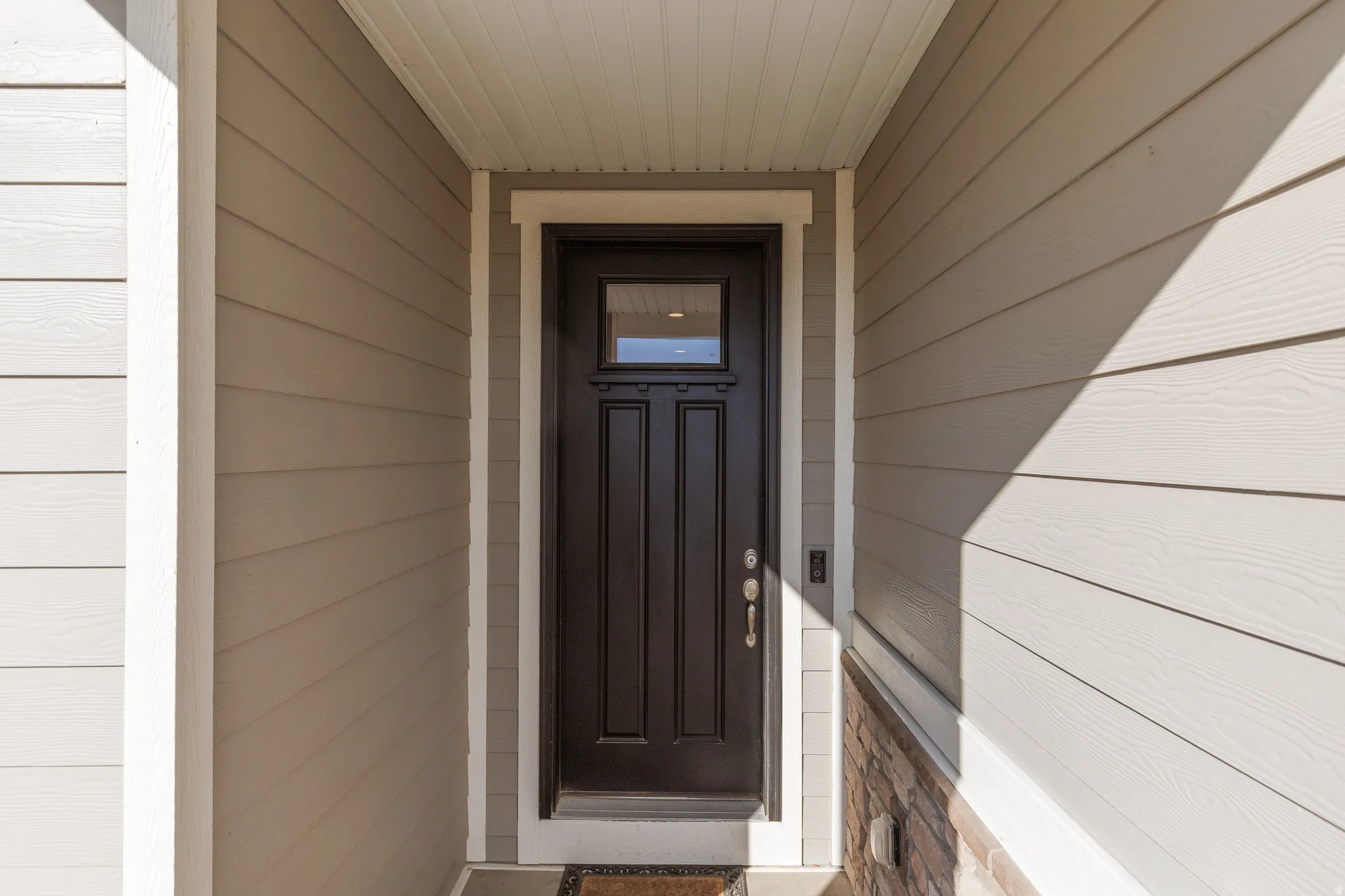 View of exterior entry and enclosed porch.