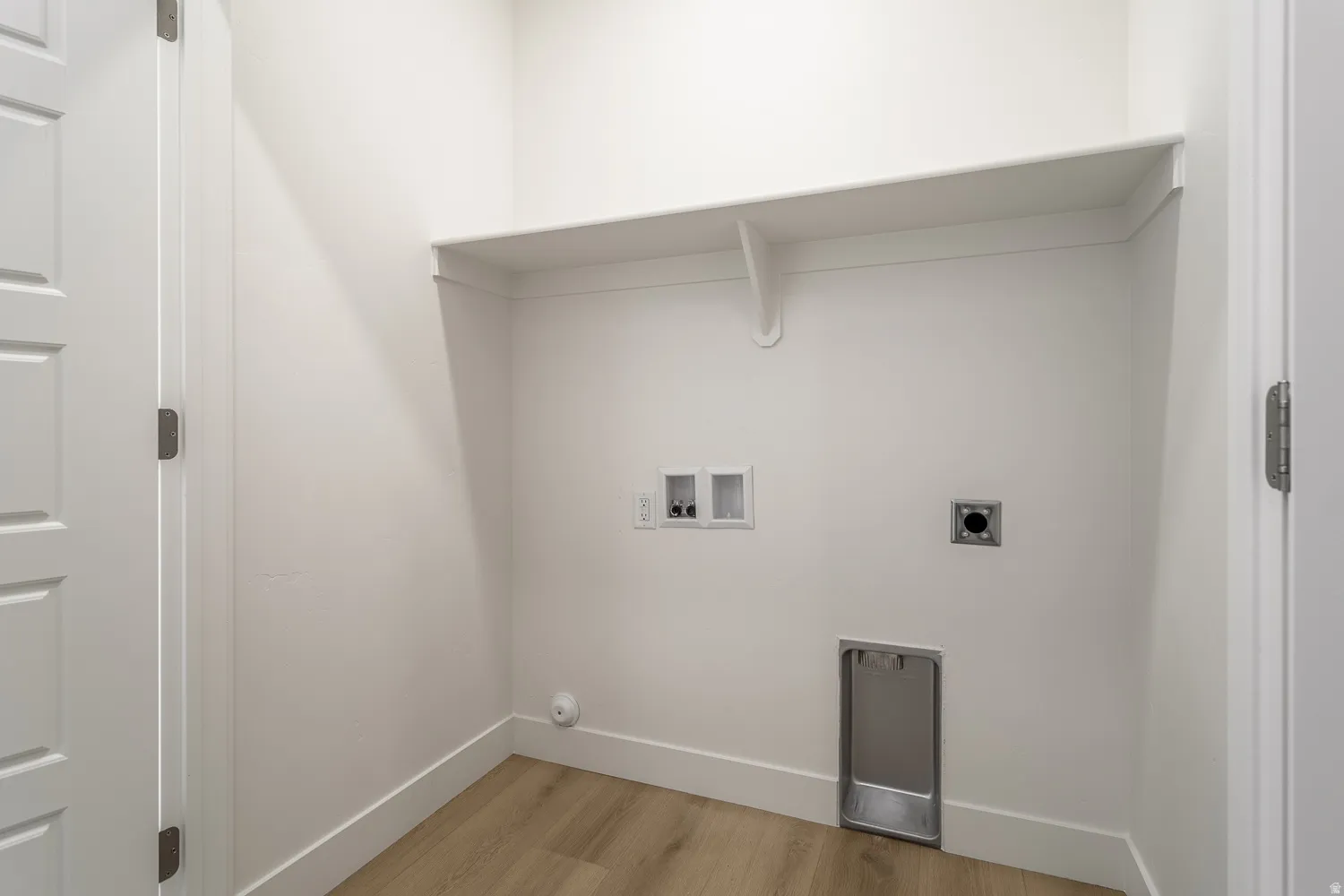 Laundry room featuring light wood-style flooring, washer hookup, and hookup for an electric dryer