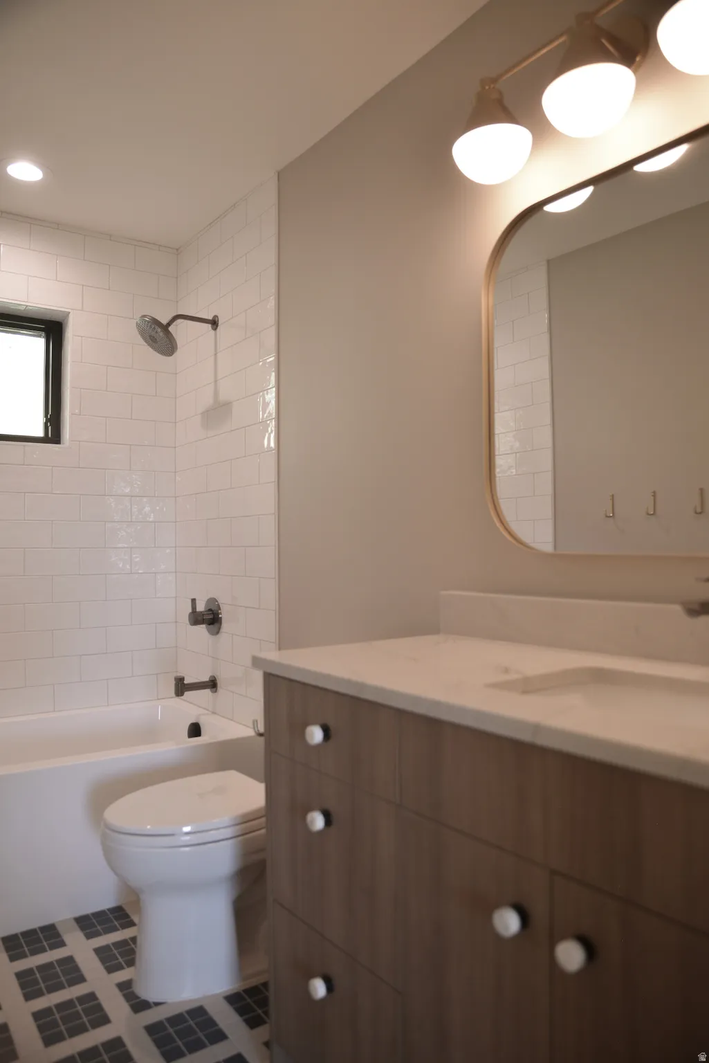 Bathroom with vanity, shower / tub combination, tile patterned flooring, and recessed lighting