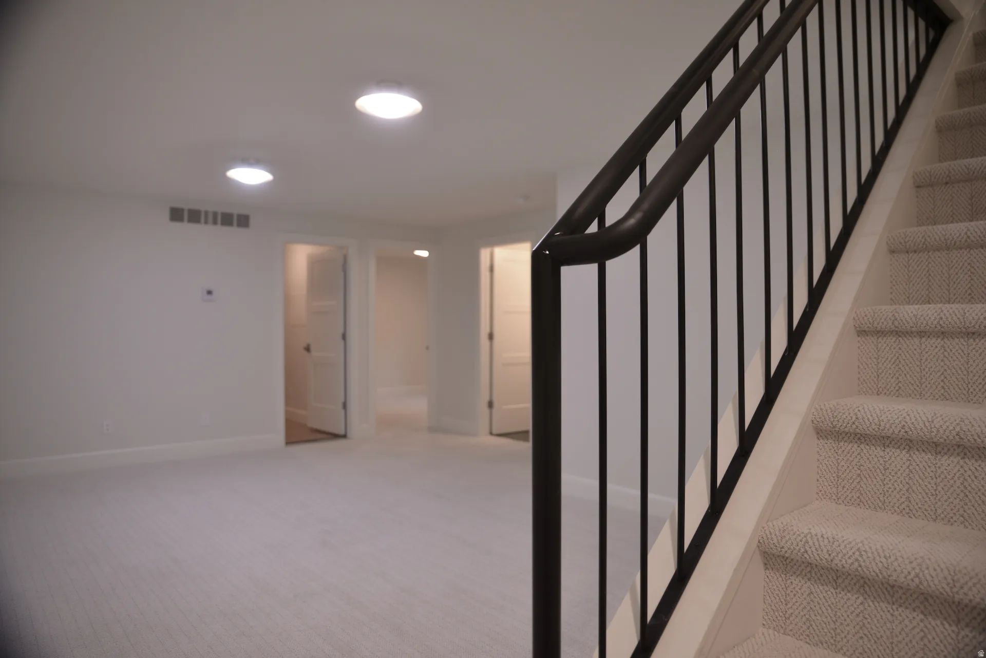 Stairs featuring carpet floors and baseboards