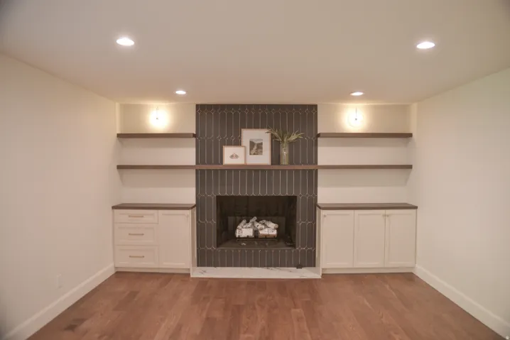Unfurnished living room featuring a fireplace, light wood-style floors, and recessed lighting
