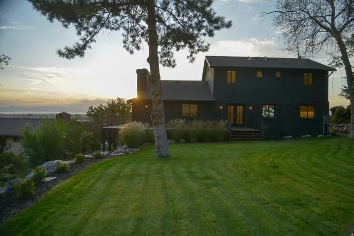 Rear view of property with a yard