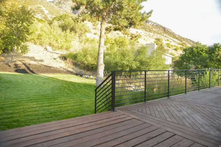 Deck with a yard and a mountain view