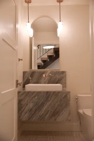 Half bath featuring vanity and toilet