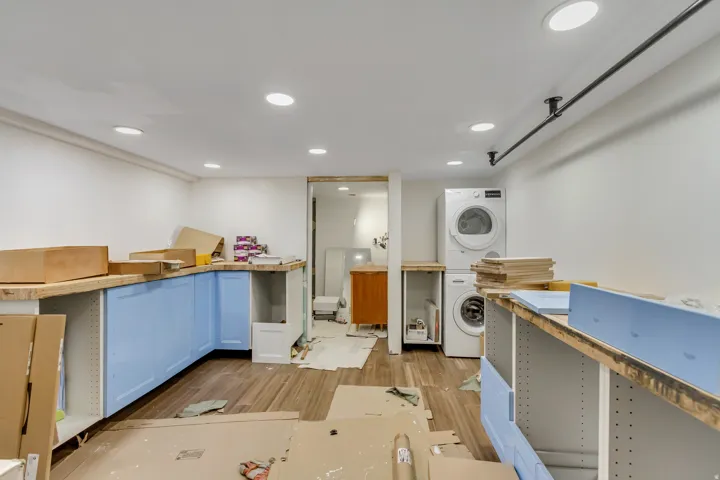 Kitchen featuring estacked washer and dryer, light wood-style floors, and recessed lighting
