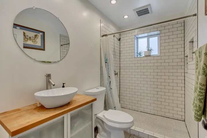 Full bath featuring vanity, a stall shower, and recessed lighting