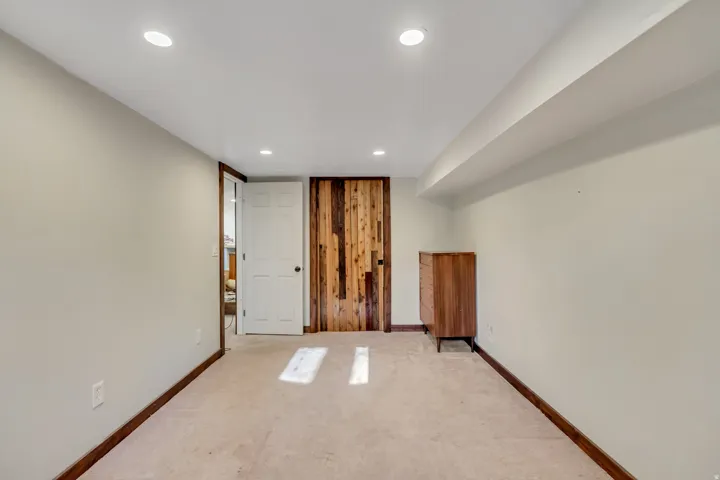 Carpeted empty room with baseboards and recessed lighting
