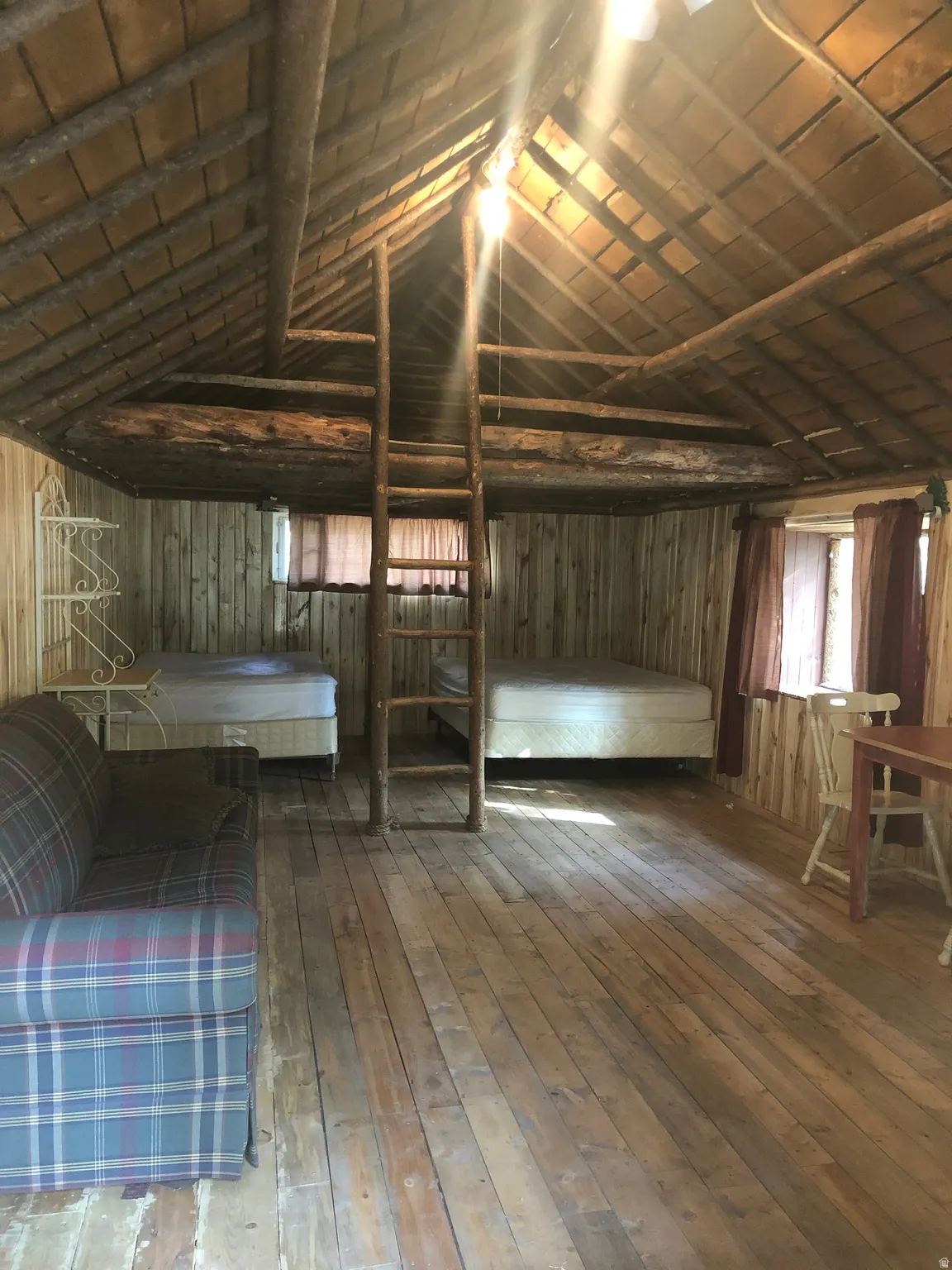 Miscellaneous room with hardwood / wood-style flooring, plenty of natural light, lofted ceiling, and wooden walls