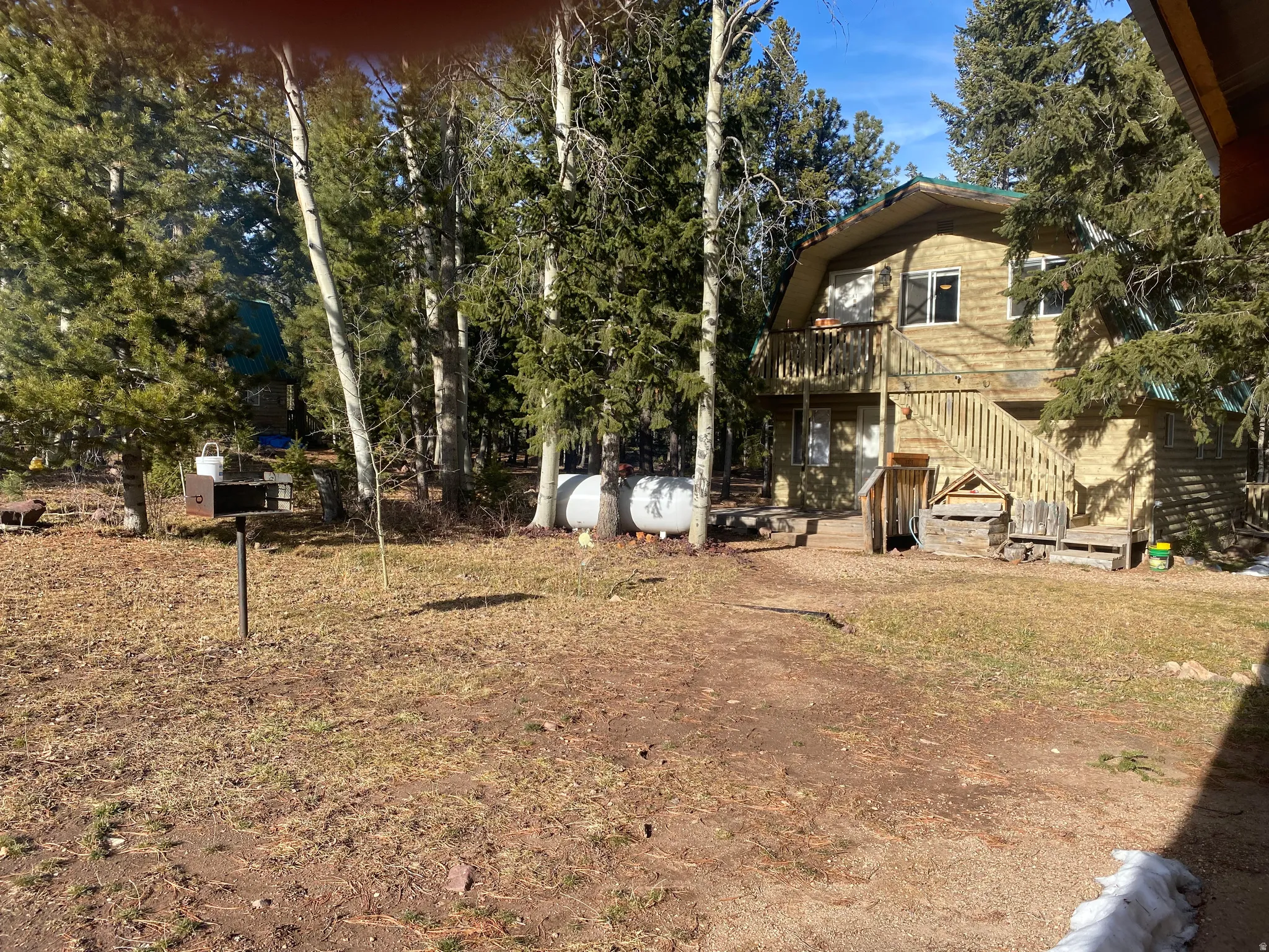 View of yard with stairway and a deck