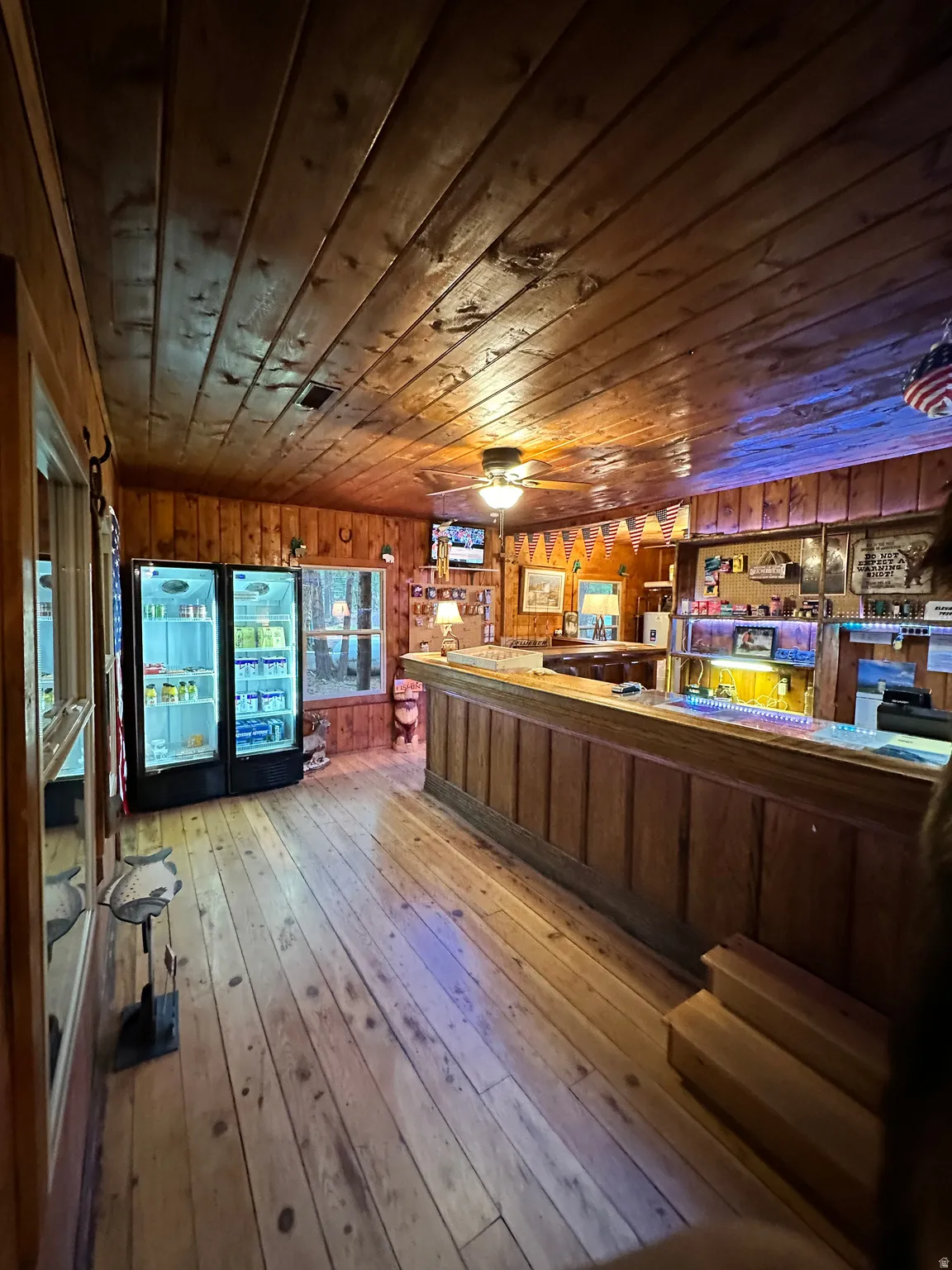 Bar area featuring wooden walls, wooden ceiling, and light countertops