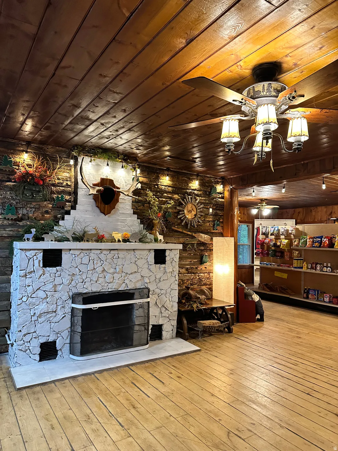 Living room featuring wooden ceiling, wood-type flooring, and a fireplace