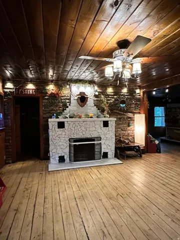 Unfurnished living room with wooden ceiling, light wood finished floors, and a fireplace