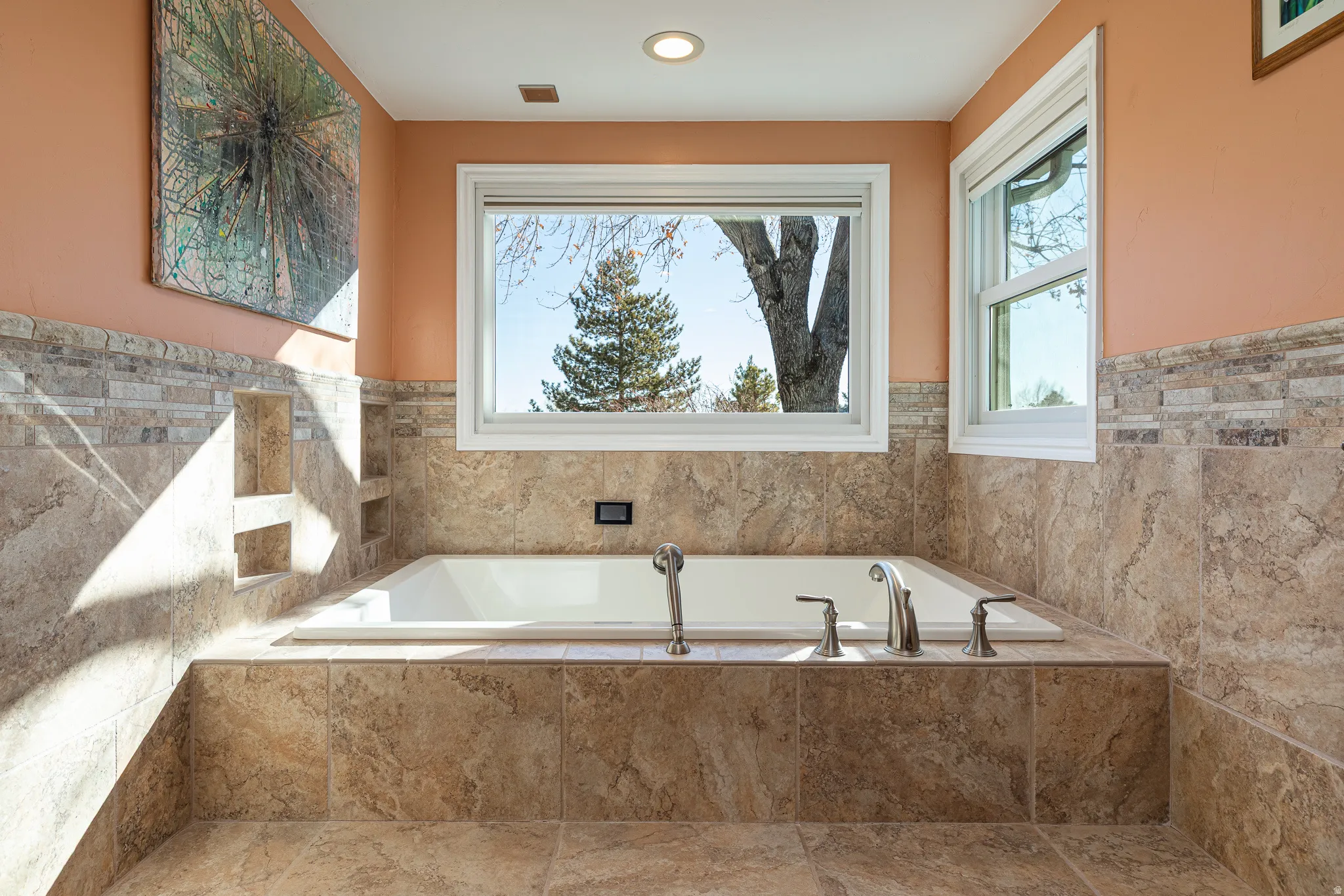 Bathroom featuring a wainscoted tile wall, a garden tub, and recessed lighting