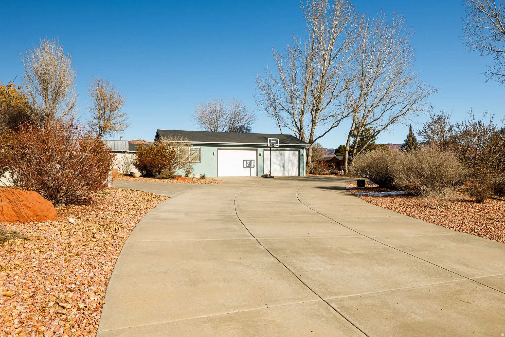 Southern view of house featuring a 3-car garage and driveway