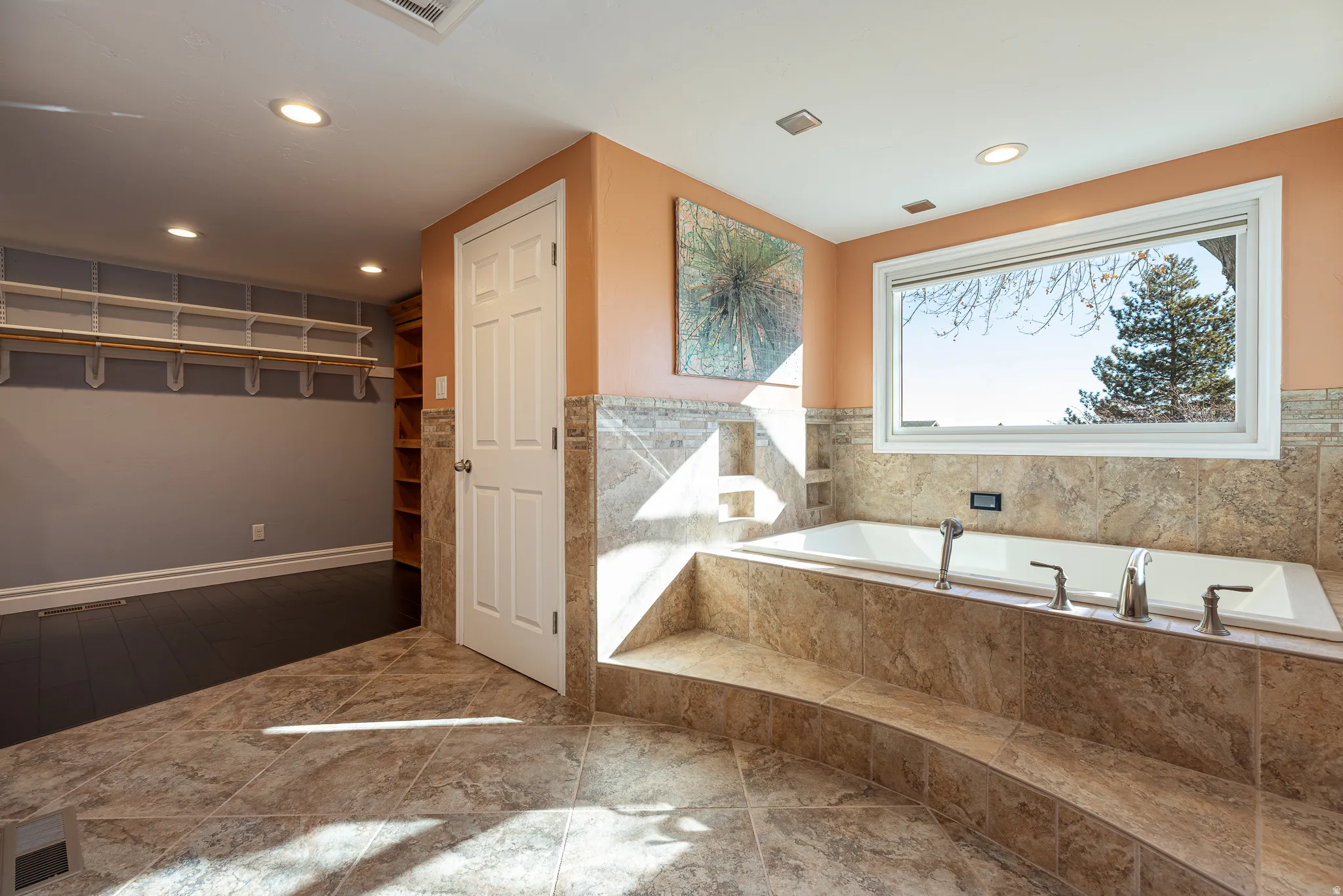 Full bathroom with a garden tub, recessed lighting, and a spacious closet