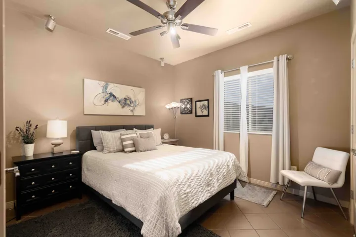 Bedroom featuring tile patterned floors and a ceiling fan
