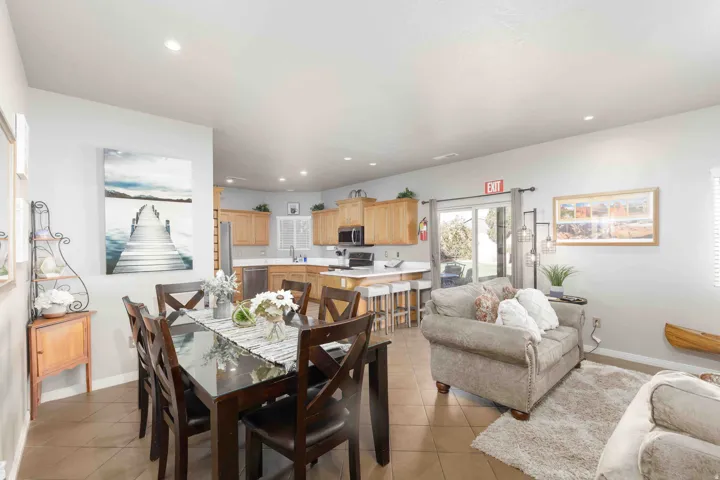 Dining room with light tile patterned flooring and recessed lighting