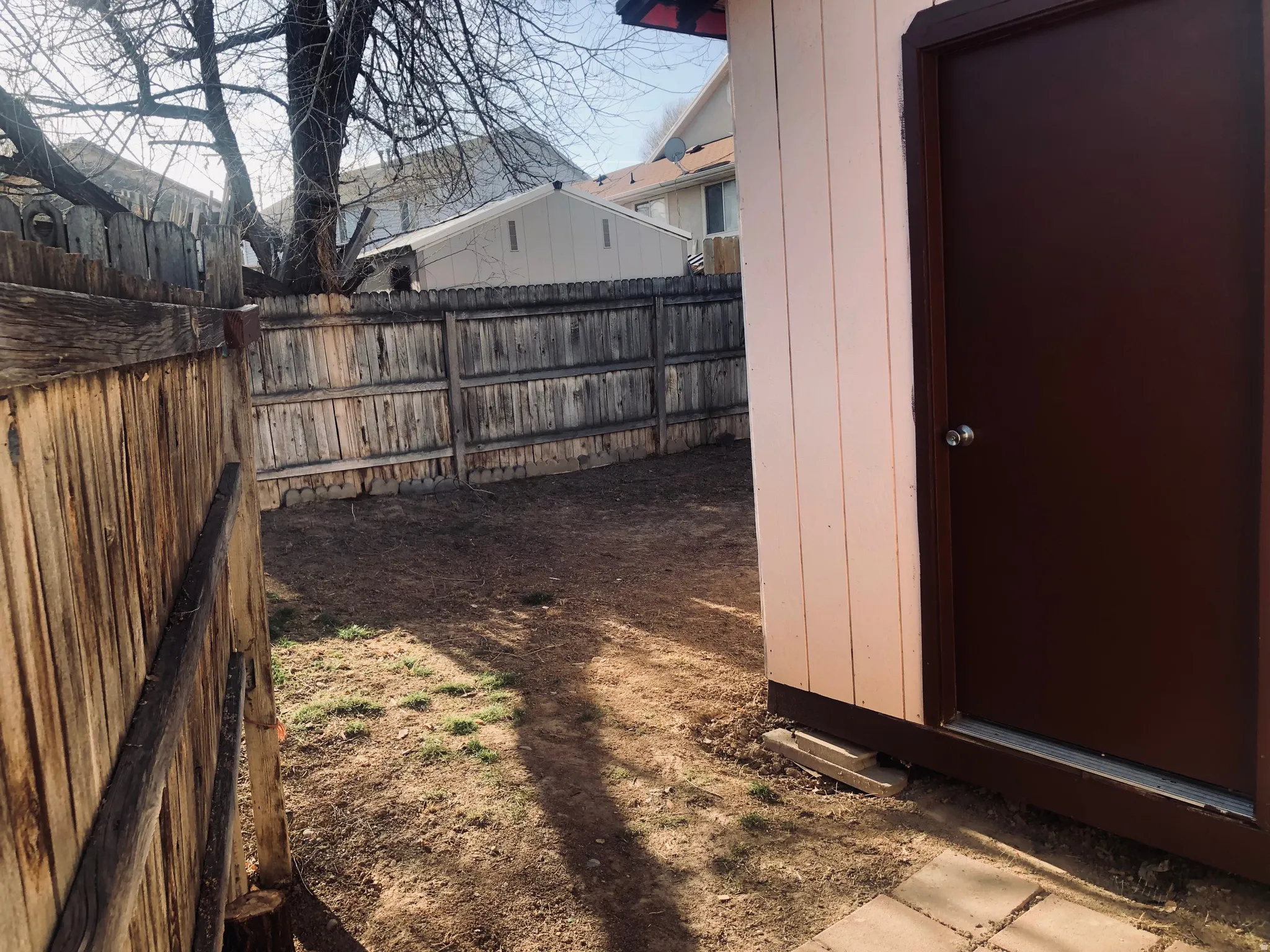 Fenced yard with an outbuilding