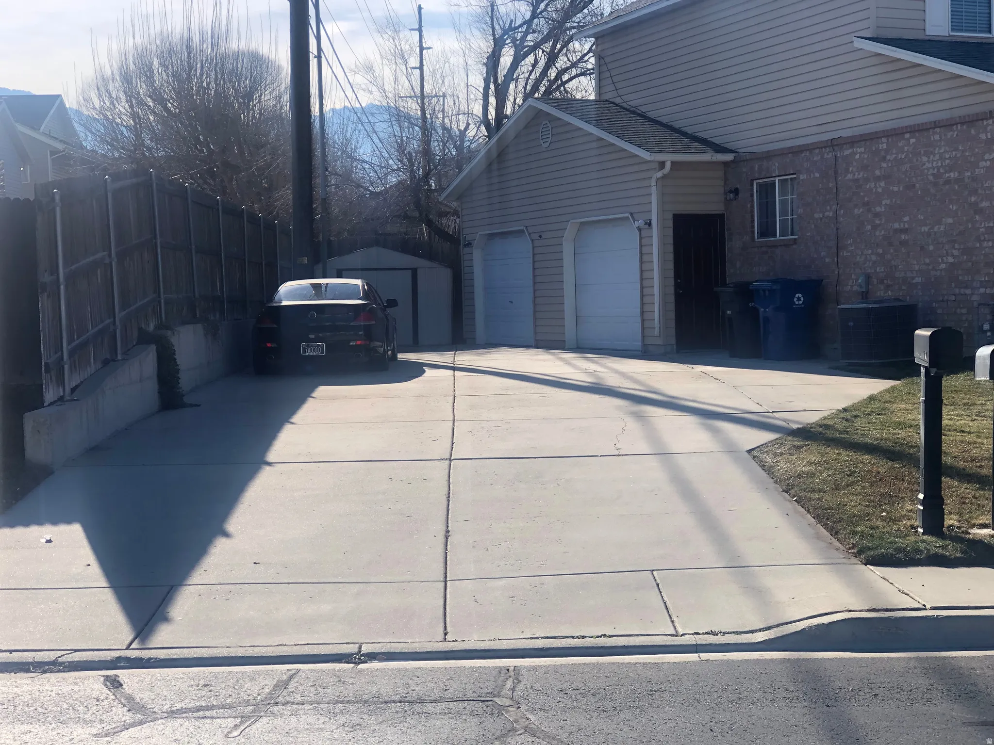 View of side of property with concrete driveway and a garage