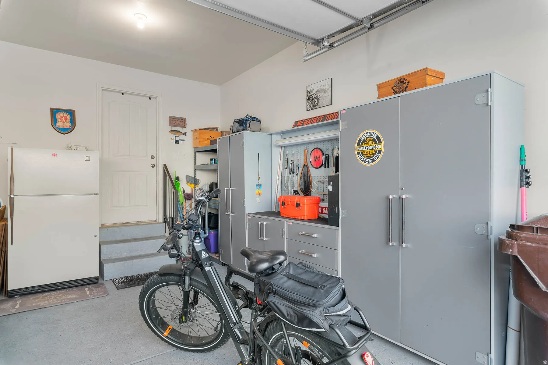 Garage featuring freestanding refrigerator