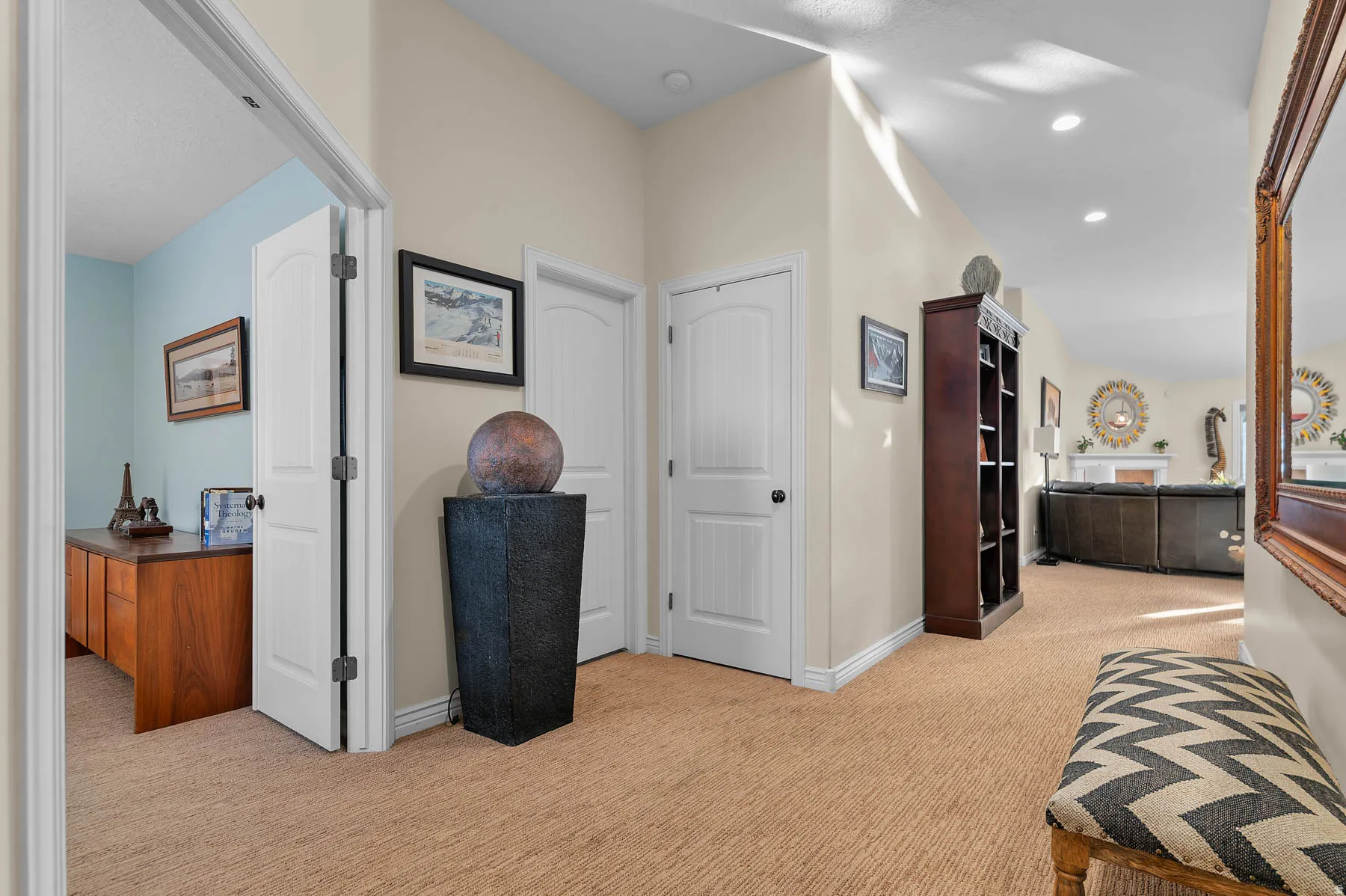 Corridor with light carpet and recessed lighting