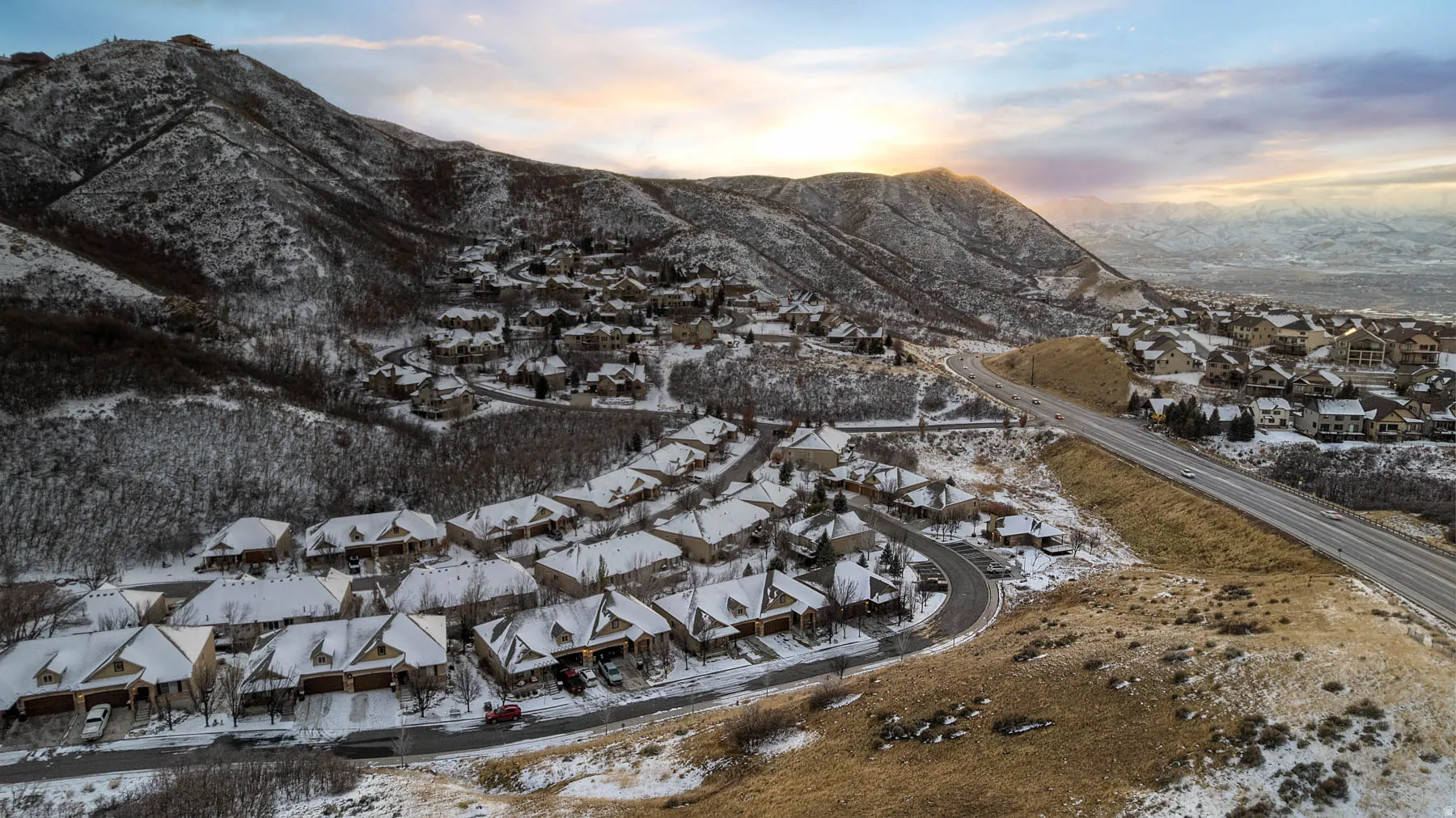 Snowy aerial view with a residential view and a mountain view