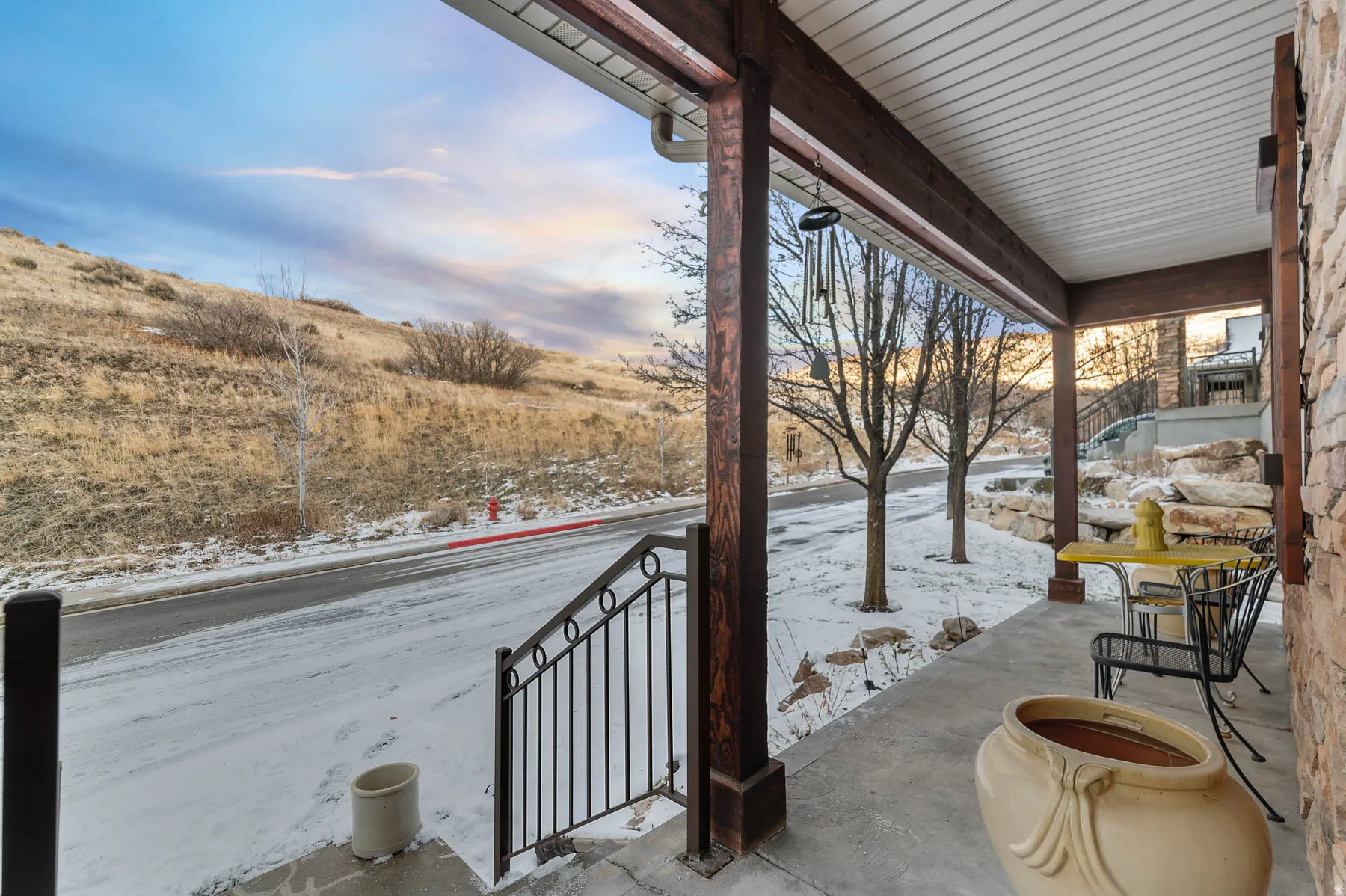 Snow covered patio with a porch