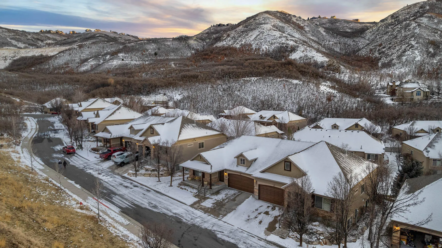 Snowy aerial view featuring a mountain view and a residential view