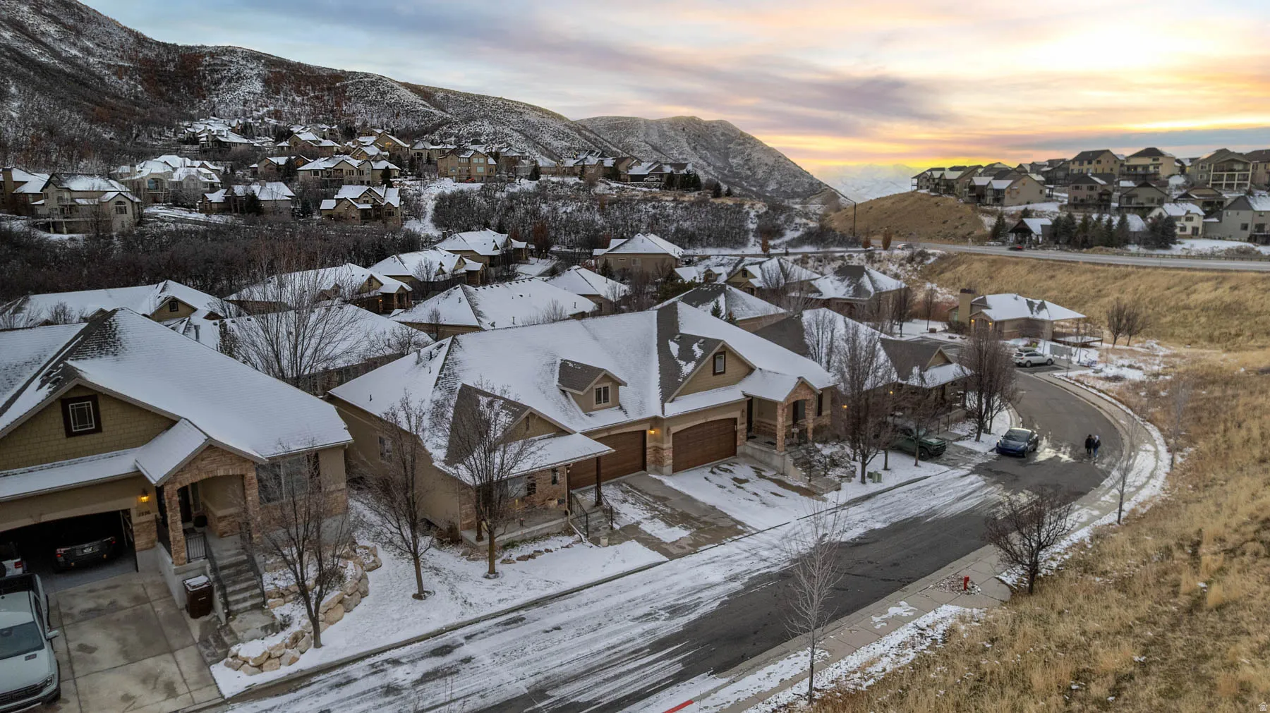 Snowy aerial view featuring a residential view and a mountain view