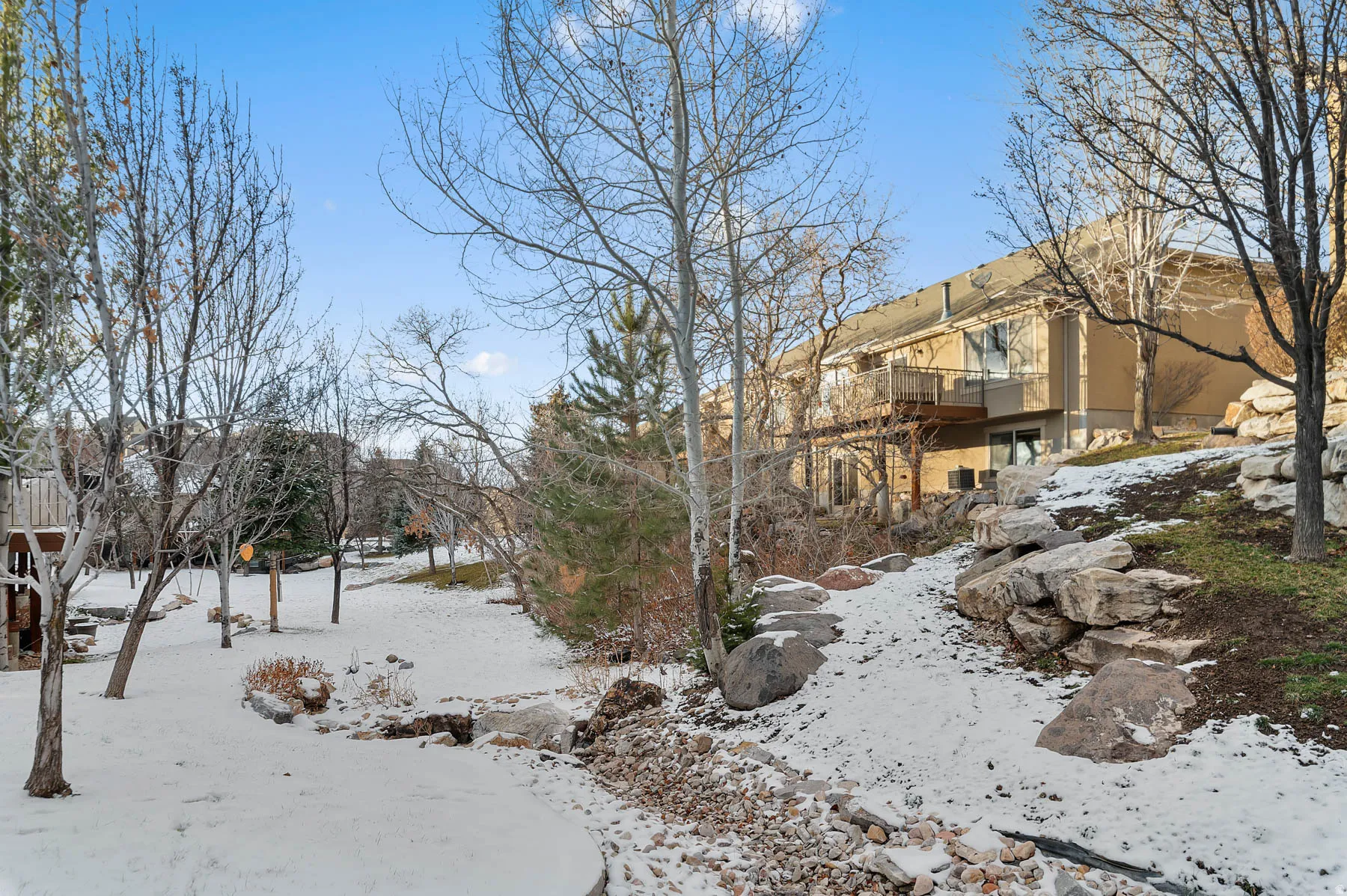 Snowy yard featuring a balcony