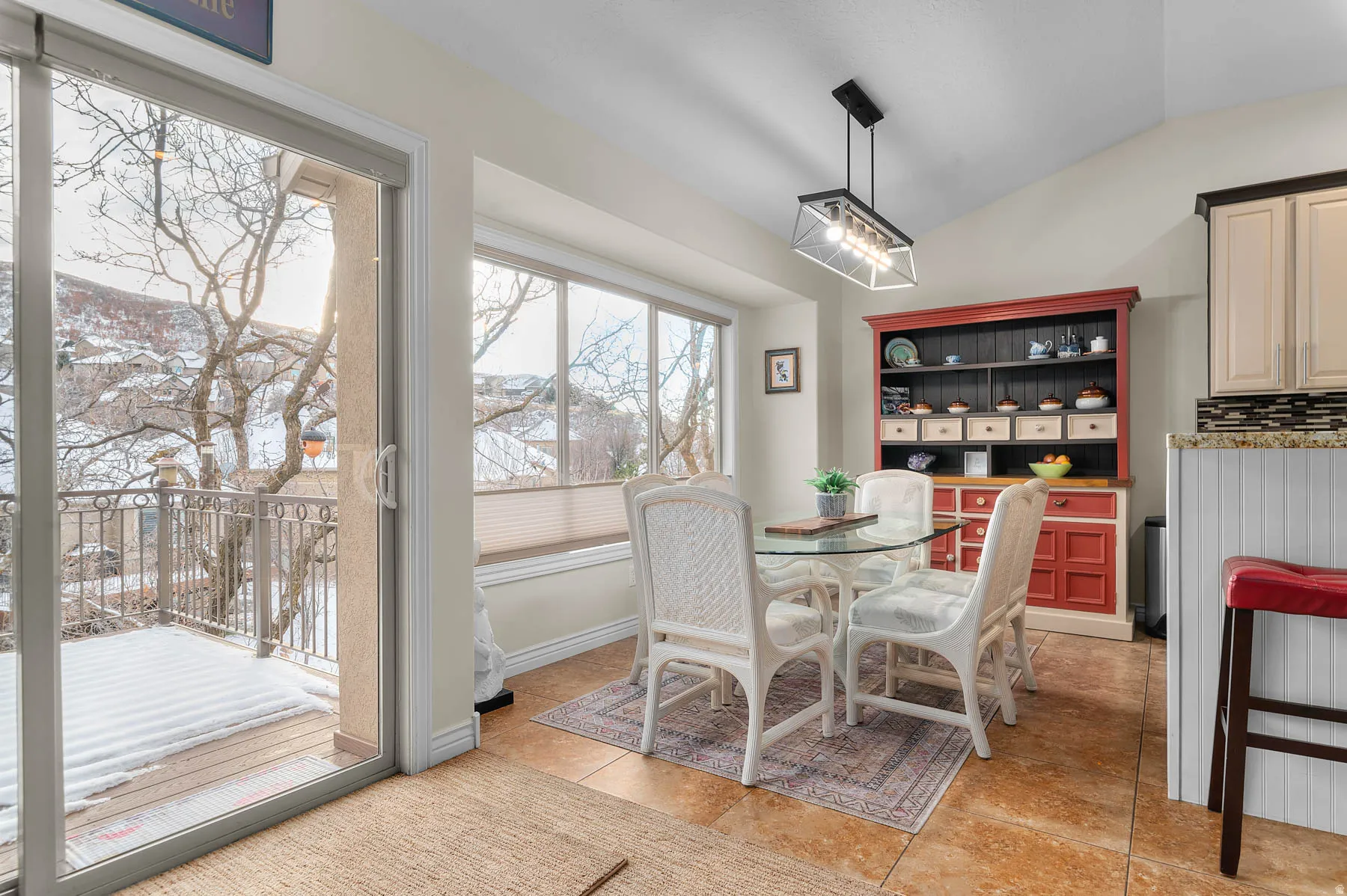 Dining area featuring lofted ceiling and light tile patterned flooring