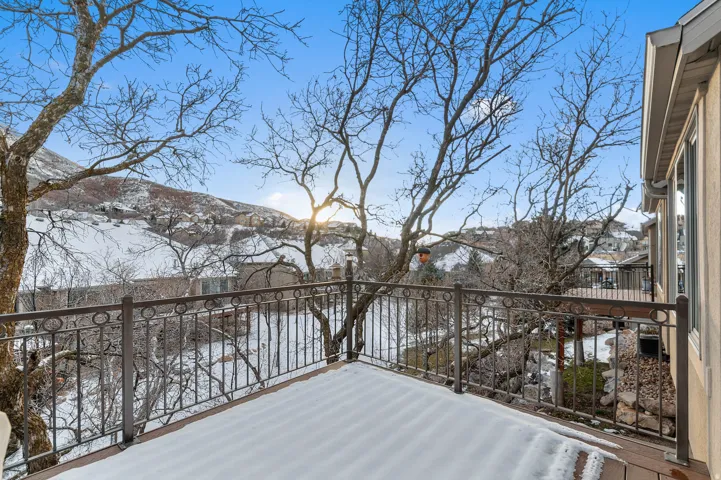 Snow covered deck with a balcony