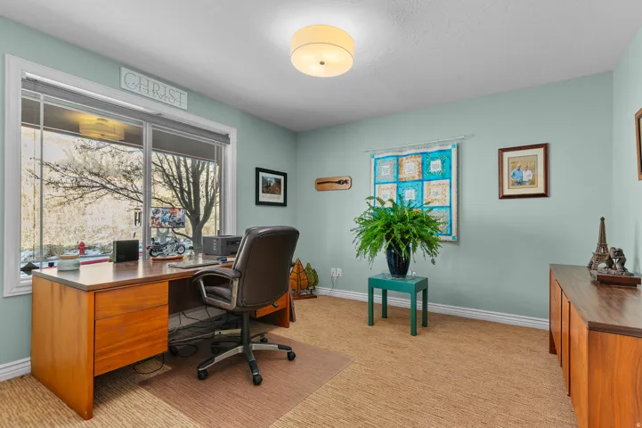 Home office featuring baseboards and light colored carpet