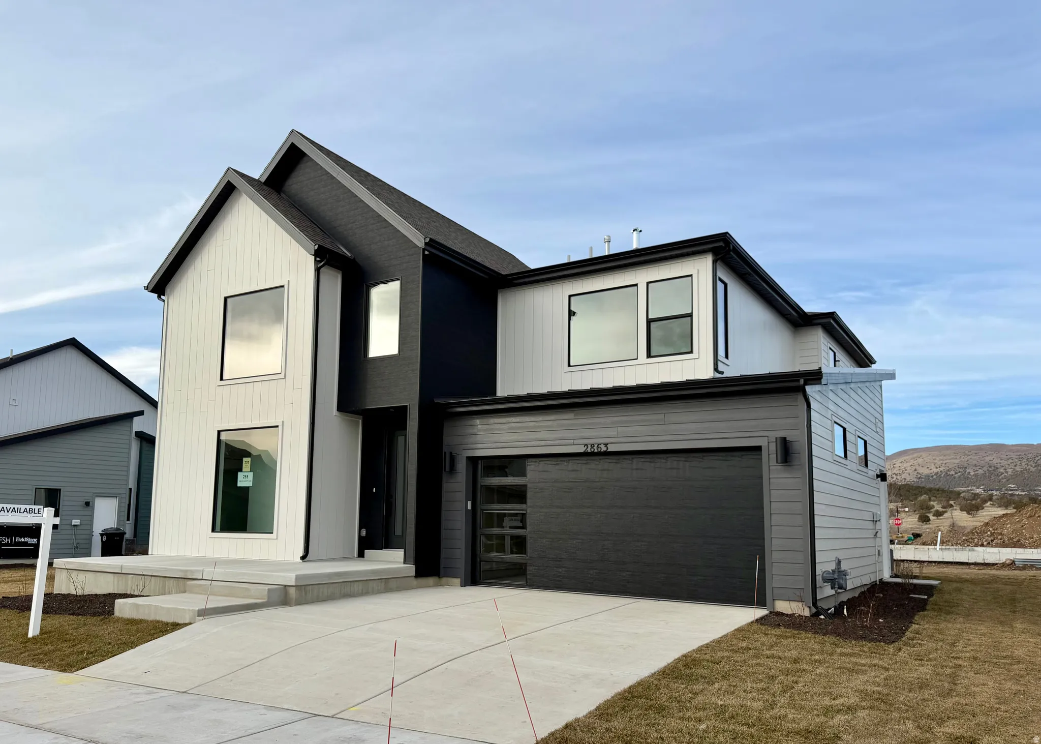 View of front of home featuring a garage and concrete driveway
