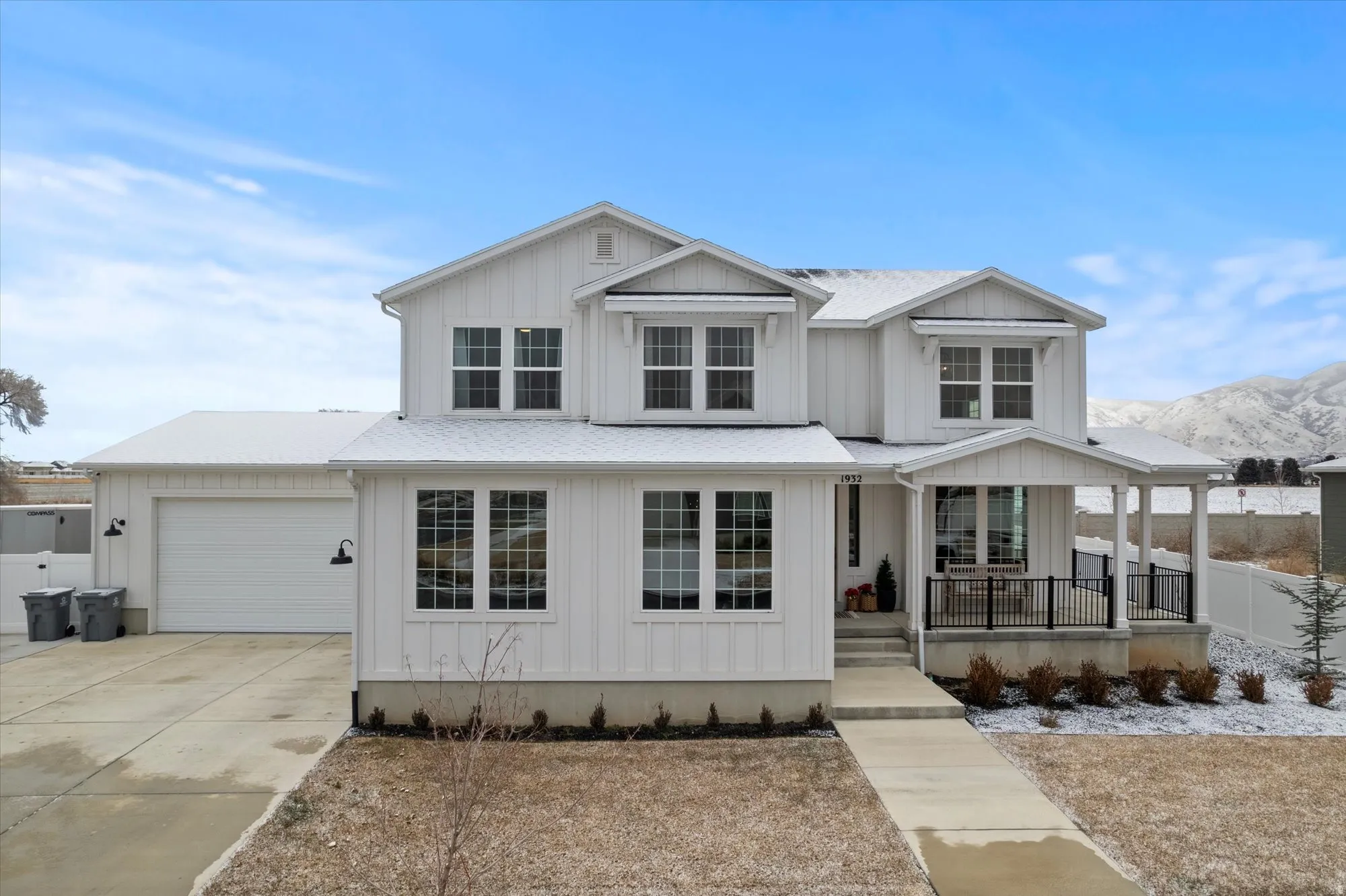 View of front of property featuring covered porch, board and batten siding, concrete driveway, and a garage