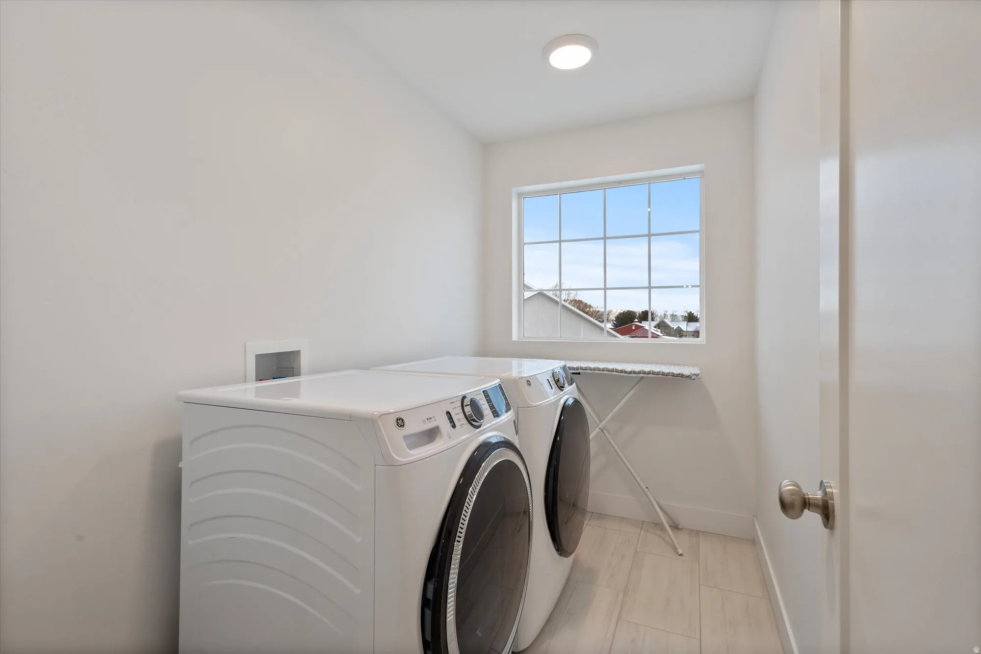 Laundry room featuring independent washer and dryer and baseboards