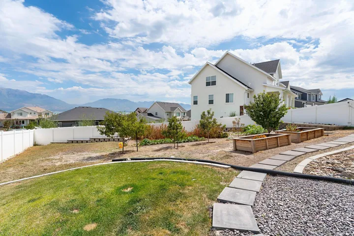 Fenced backyard with a residential view and a garden