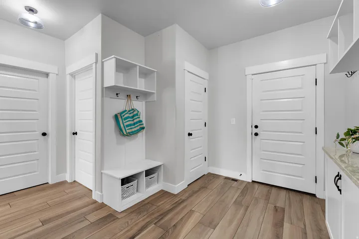 Mudroom with light wood-type flooring and baseboards