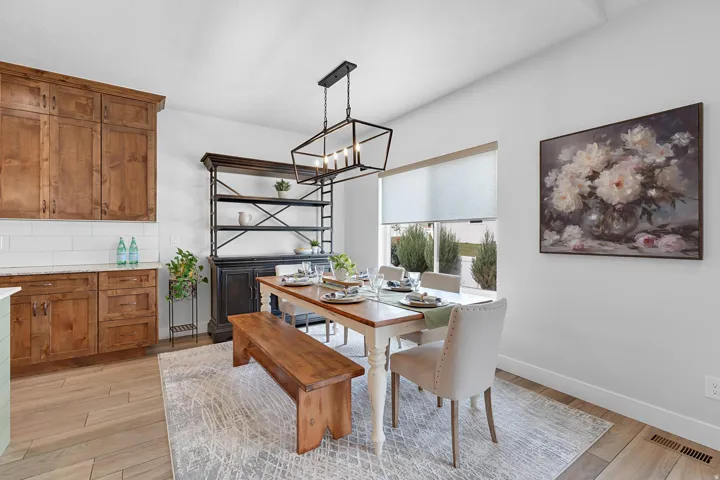 Dining room with light wood-style flooring and a chandelier