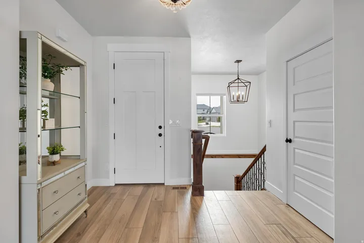 Entryway with a chandelier and light wood-type flooring