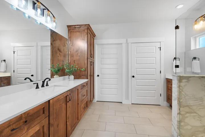 Full bath with vanity and light tile patterned flooring