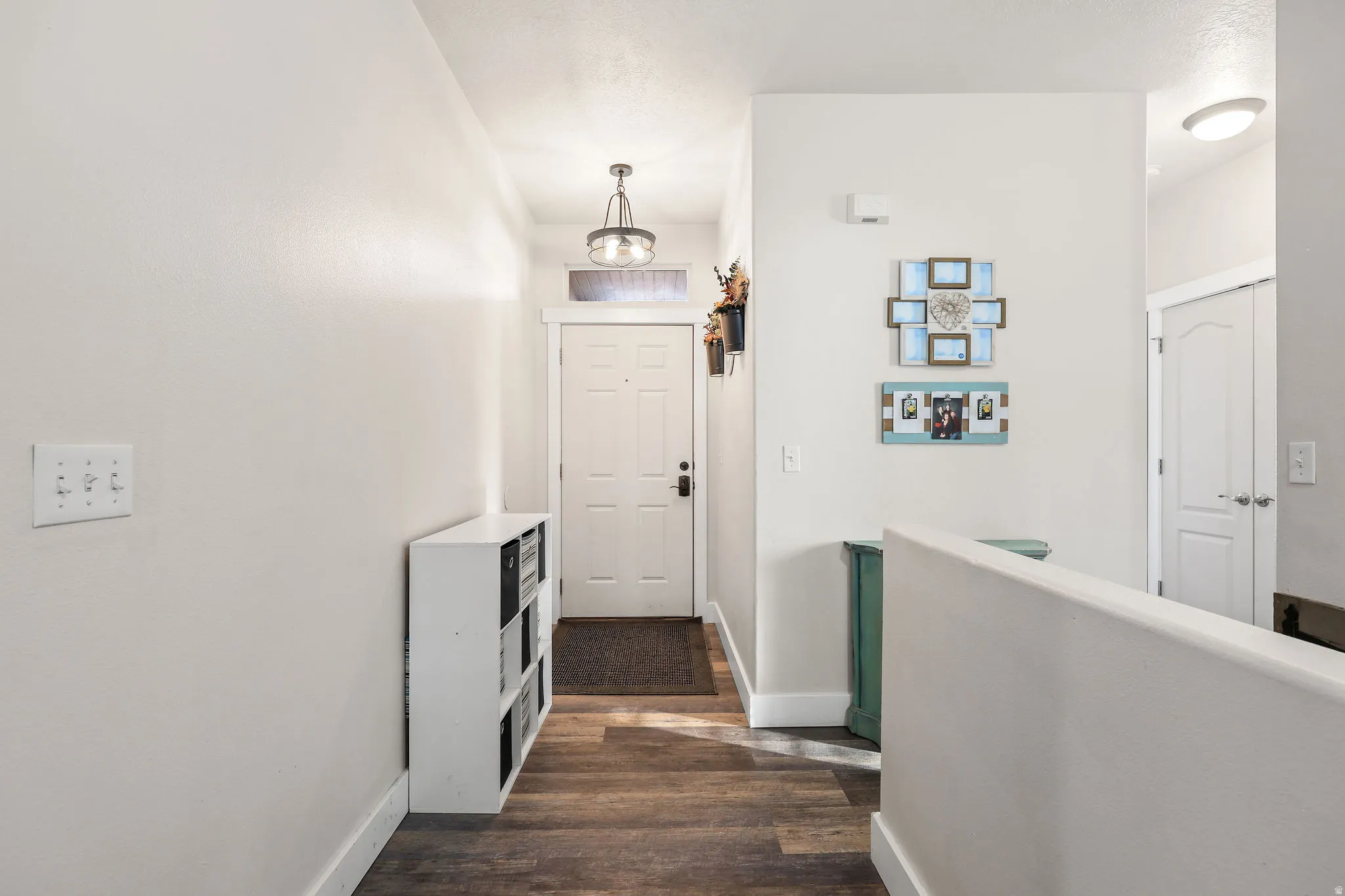 Hallway with baseboards and dark wood-style floors