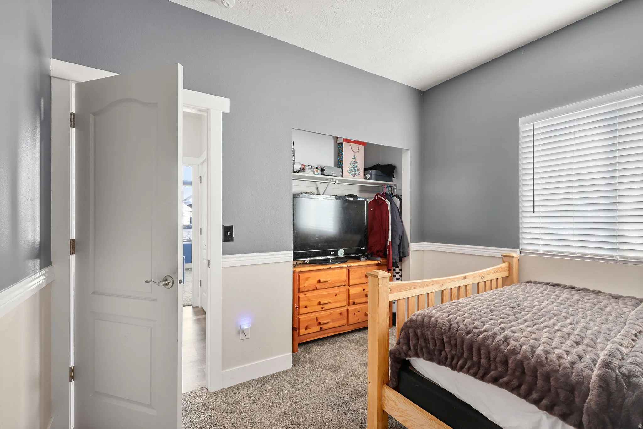 Bedroom featuring light colored carpet and baseboards